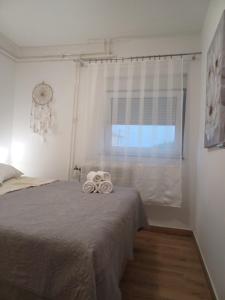 a bedroom with a bed with two towels on it at Apartment Banjol 4965b in Rab