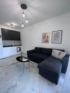 a living room with a couch and a table at ἕαR Exceptional Residence in Nea Peramos