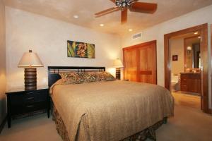 a bedroom with a bed and a ceiling fan at MAKENA SURF #B304 condo in Wailea
