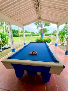 a pool table on a patio with awning at Finca Hacienda el Morichal in Villavicencio