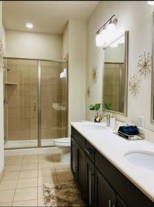 a bathroom with a shower and a sink and a toilet at Texan Blues in Houston