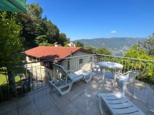 a balcony with a table and chairs and a table at Casa de Casarelhos - Andar da Moradia com terraço - Vistas rio - "Gerês" in Geres