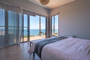 a bedroom with a bed and a view of the ocean at The Cove Tasmania in Devonport