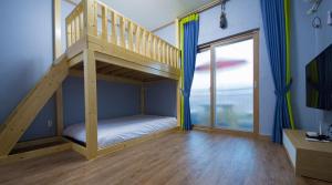 a bunk bed in a room with a staircase at Suncheon Bay Ecology Pension in Suncheon