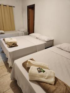 A bed or beds in a room at Barão apto-hotel