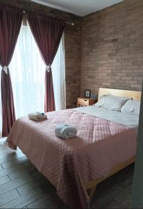 a bedroom with a large bed with two towels on it at Corazón y color in Oaxaca City