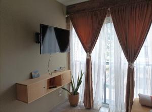 a living room with a tv and a large window at Corazón y color in Oaxaca City