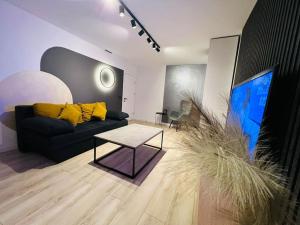 a living room with a couch and a tv at Impact Apartments in Piteşti +2 photos