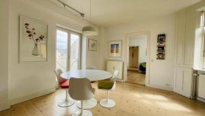 a dining room with a white table and chairs at ApartmentInCopenhagen Apartment 664 in Copenhagen