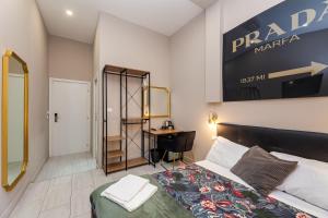 A bed or beds in a room at Empire Suites