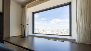 a room with a large window with a view of a city at ANA Crowne Plaza Hotel Grand Court Nagoya, an IHG Hotel in Nagoya