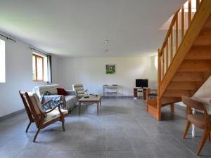 a living room with a couch and a staircase at Spacious Cottage with Private Garden in Normandy in Le Bourg-Dun