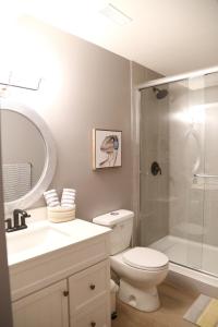 a bathroom with a shower and a toilet and a sink at Yucca Tree in Kelowna