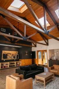 a living room with a black couch and a table at LOGE Wolf Creek in South Fork