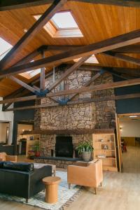 a large living room with a stone fireplace at LOGE Wolf Creek in South Fork