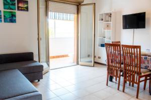 a living room with a couch and a table and chairs at [600 metri dal mare] Relax con fresco terrazzo in Marina di Andora