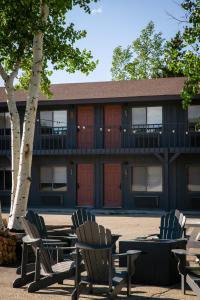 a group of chairs sitting in front of a building at LOGE Wolf Creek in South Fork