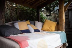 a bed with pillows on it under a gazebo at Charming 2-Bed Cabin in Sutton Coldfield in Sutton Coldfield