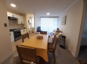 a kitchen and dining room with a table and chairs at Chillan Centro in Chillán