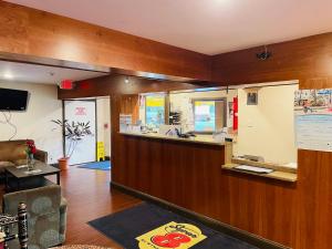 a lobby with a reception counter in a building at Super 8 by Wyndham Gloucester in Gloucester City