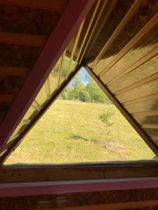 a view from a attic window in a roof at Căbănuță rustică 02 in Băniţa
