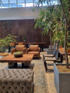 a living room with a table and chairs and a table and a table sidx sidx at Brittany Hotel BGC in Manila