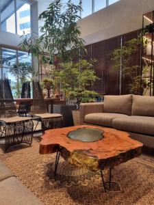 a living room with a tree stump coffee table at Brittany Hotel BGC in Manila