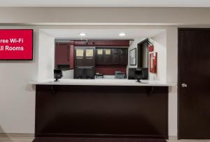 a kitchen with red cabinets and a white counter top at Red Roof Inn Mansfield in Mansfield