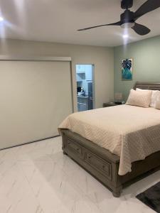 a bedroom with a bed and a ceiling fan at City View Luxury Home in Montego Bay
