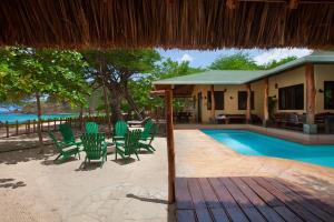 a resort with a pool and chairs and a house at Casa Yosi, Beach Front Piece of Heaven in San Juan del Sur