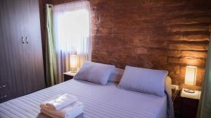 a bedroom with a bed with towels on it at Hostal Solor in San Pedro de Atacama