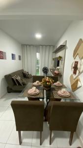 a living room with a table and a couch at Flat Muro Alto Porto de Galinhas in Porto De Galinhas