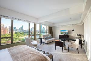 a bedroom with a view of a city at Marco Polo Xiamen in Xiamen