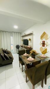 a living room with a table and a couch at Flat Muro Alto Porto de Galinhas in Porto De Galinhas