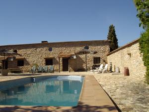 a house with a swimming pool in front of a building at House No 02 median in Humilladero