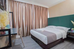 Postel nebo postele na pokoji v ubytování Hotel 28 Titiwangsa