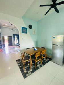 y cocina con mesa y sillas y ventilador de techo. en NS Vacation Home Muar with Kids Friendly Pool en Muar