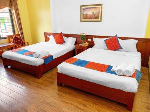 Postel nebo postele na pokoji v ubytování Cherry Hotel
