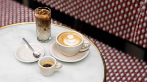 a table with two cups of coffee on it at Hotel Indigo Paris - Opera by IHG in Paris