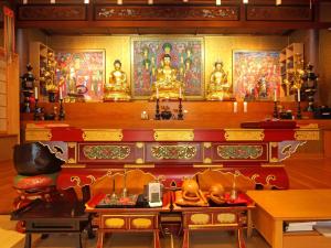 a room with a altar in a temple with gold statues at 金剛寺 宿坊 成穂院 in Matsukawa