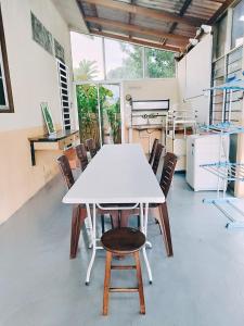 a white table and chairs in a kitchen at Miza Homestay in Kuala Terengganu