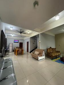 a large living room with couches and a tv at Hidayah Homestay Tawau in Kampong Parit