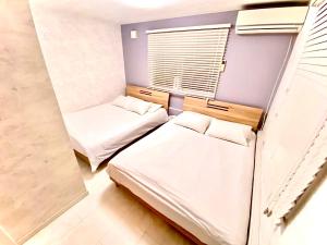 Кровать или кровати в номере Eternity HOUSE 新宿大久保
