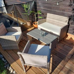 a patio with a table and chairs on a deck at La Cas'Aline in La Saline les Bains