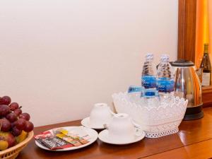 a table with bottles of water and a basket of fruit at 360 Resort in Sihanoukville