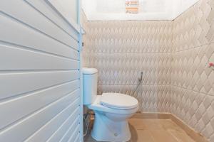 - une salle de bains avec des toilettes blanches dans une cabine dans l'établissement RedDoorz @ Niagara Waterpark, à Maracang-tua