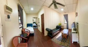 a living room with a couch and a bed at DGeting Beach Resort in Tumpat