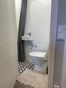 a bathroom with a sink and a toilet at Harry Hans Beach Apartment in Pärnu