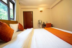 Tempat tidur dalam kamar di Hotel Pala