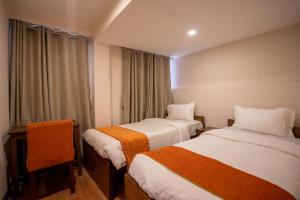Tempat tidur dalam kamar di Hotel Pala